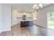 Eat-in kitchen with island, white cabinets, and hardwood floors at 37 Baird Cv Ln, Angier, NC 27501
