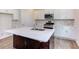 Kitchen island with white quartz countertop and dark brown cabinetry at 37 Baird Cv Ln, Angier, NC 27501