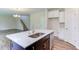 Kitchen island with white quartz countertop and stainless steel sink at 37 Baird Cv Ln, Angier, NC 27501