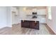 Modern kitchen with white cabinets, quartz countertops, and stainless steel appliances at 37 Baird Cv Ln, Angier, NC 27501