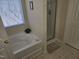 Bathroom featuring corner bathtub and a separate shower stall at 401 Ganyard Farm Way, Durham, NC 27703