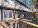 Rear patio and exterior featuring double glass doors, an outdoor grill, and a privacy fence at 4236 Lake Ridge Dr, Raleigh, NC 27604