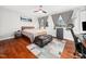 Bright bedroom with hardwood floors, two windows, ceiling fan, and an accent rug at 4236 Lake Ridge Dr, Raleigh, NC 27604
