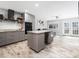 Modern kitchen with gray cabinets, granite counters, stainless steel appliances, and a central island at 4236 Lake Ridge Dr, Raleigh, NC 27604