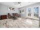 Comfortable living area with a sofa, coffee table, neutral walls and french doors to the backyard at 4236 Lake Ridge Dr, Raleigh, NC 27604
