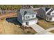 Aerial view of a two-story home with a gray exterior, landscaped front yard, and a two-car garage at 48 Railcar Way # Homesite 2, Clayton, NC 27520