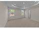 Spacious bedroom with two windows and plush carpeting at 48 Railcar Way, Clayton, NC 27520