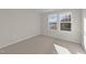Bright bedroom with carpet and large windows at 48 Railcar Way, Clayton, NC 27520