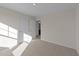 Spacious bedroom with plush carpeting and an adjacent bathroom at 48 Railcar Way, Clayton, NC 27520