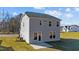 Two-story home with gray siding and a patio at 48 Railcar Way, Clayton, NC 27520