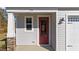 Close-up of the front door with stone accents and a charming exterior light at 48 Railcar Way, Clayton, NC 27520
