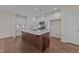 Modern kitchen with marble backsplash, stainless appliances, and a large island at 48 Railcar Way, Clayton, NC 27520