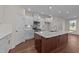 Modern kitchen with island and stainless steel appliances at 48 Railcar Way, Clayton, NC 27520