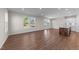 Open concept living space with wood floors and natural light from the large windows at 48 Railcar Way, Clayton, NC 27520