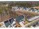 Aerial view of a neighborhood with new homes and trees surrounding the community at 645 Silvercomet Dr, Knightdale, NC 27545