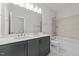 Bathroom with tiled floors, double vanity, and a shower-tub combo at 645 Silvercomet Dr, Knightdale, NC 27545
