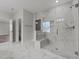 Modern bathroom with glass-enclosed shower, marble tiling, and recessed lighting, offering a sleek design at 645 Silvercomet Dr, Knightdale, NC 27545