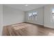 Bright bedroom with wood-look floors, large window and recessed lighting at 645 Silvercomet Dr, Knightdale, NC 27545