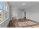 Spacious bedroom with wood-look floors, multiple doors, and a view to the outside at 645 Silvercomet Dr, Knightdale, NC 27545