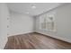 Bright bedroom with wood floors, natural light from the large windows at 645 Silvercomet Dr, Knightdale, NC 27545