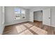 Sunlit bedroom features hardwood floors, fresh white walls, and an inviting open doorway at 645 Silvercomet Dr, Knightdale, NC 27545