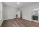 Bright bedroom features hardwood floors, white walls, ensuite bathroom, and walk in closet at 645 Silvercomet Dr, Knightdale, NC 27545