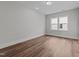 A bright bedroom with wood floors and large window at 645 Silvercomet Dr, Knightdale, NC 27545