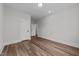 Bedroom featuring wood-look floors, recessed lighting, and white doors at 645 Silvercomet Dr, Knightdale, NC 27545