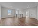 Bright bonus room featuring hardwood floors, neutral paint, and natural light from multiple windows at 645 Silvercomet Dr, Knightdale, NC 27545