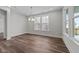 Bright dining room features wood floors and a chandelier, with abundant natural light at 645 Silvercomet Dr, Knightdale, NC 27545