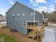 Back exterior of a two story home with a spacious deck and stair access at 645 Silvercomet Dr, Knightdale, NC 27545