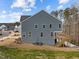 Exterior back of house with a walkout deck, six windows, and stairs at 645 Silvercomet Dr, Knightdale, NC 27545
