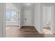 An inviting foyer features hardwood floors, neutral walls, and views of a half-bath at 645 Silvercomet Dr, Knightdale, NC 27545