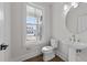 Bright half-bath with a pedestal sink, a toilet, and a window offering natural light at 645 Silvercomet Dr, Knightdale, NC 27545