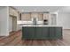 Spacious kitchen with large island featuring pendant lighting, seating, and stainless appliances at 645 Silvercomet Dr, Knightdale, NC 27545