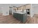 Gourmet kitchen with island, stainless appliances, custom cabinets and wood floors at 645 Silvercomet Dr, Knightdale, NC 27545