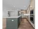 Open kitchen features a large island with seating, stainless appliances, and wood floors at 645 Silvercomet Dr, Knightdale, NC 27545