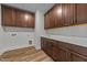 Laundry room featuring brown cabinets, white countertops, utility sink, and washer/dryer hookups at 645 Silvercomet Dr, Knightdale, NC 27545