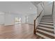 Spacious living room with a staircase, sliding glass doors to deck, and wood floors at 645 Silvercomet Dr, Knightdale, NC 27545