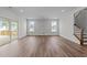 Spacious living room featuring wood floors, recessed lighting, and a sliding door to the deck at 645 Silvercomet Dr, Knightdale, NC 27545