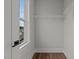 A walk-in closet with wire shelving, a window, and wood-look floors at 645 Silvercomet Dr, Knightdale, NC 27545