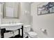 Modern powder room with pedestal sink and stylish artwork at 664 Lavenham Ln, Fuquay Varina, NC 27526