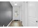 Bright entryway with dark gray accent wall and hardwood floors at 747 Creekway Dr, Fuquay Varina, NC 27526