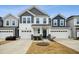 Two-story townhome with gray and white siding, two-car garage, and landscaping at 747 Creekway Dr, Fuquay Varina, NC 27526