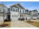 Two-story townhome with gray and white siding, two-car garage, and landscaping at 747 Creekway Dr, Fuquay Varina, NC 27526