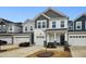 Two-story townhome with gray and white siding, two-car garage, and landscaping at 747 Creekway Dr, Fuquay Varina, NC 27526