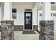 Modern black front door with glass panels and stone accents at 747 Creekway Dr, Fuquay Varina, NC 27526