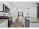 Open concept kitchen with island and stainless steel appliances at 747 Creekway Dr, Fuquay Varina, NC 27526