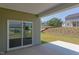 Backyard patio with sliding glass doors and view of neighborhood at 76 Brooklynn Trl, Angier, NC 27501