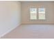 Spacious bedroom with neutral carpeting and two windows at 76 Brooklynn Trl, Angier, NC 27501